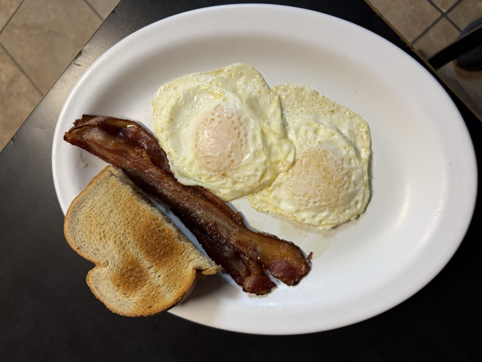 Two eggs, bacon and toast